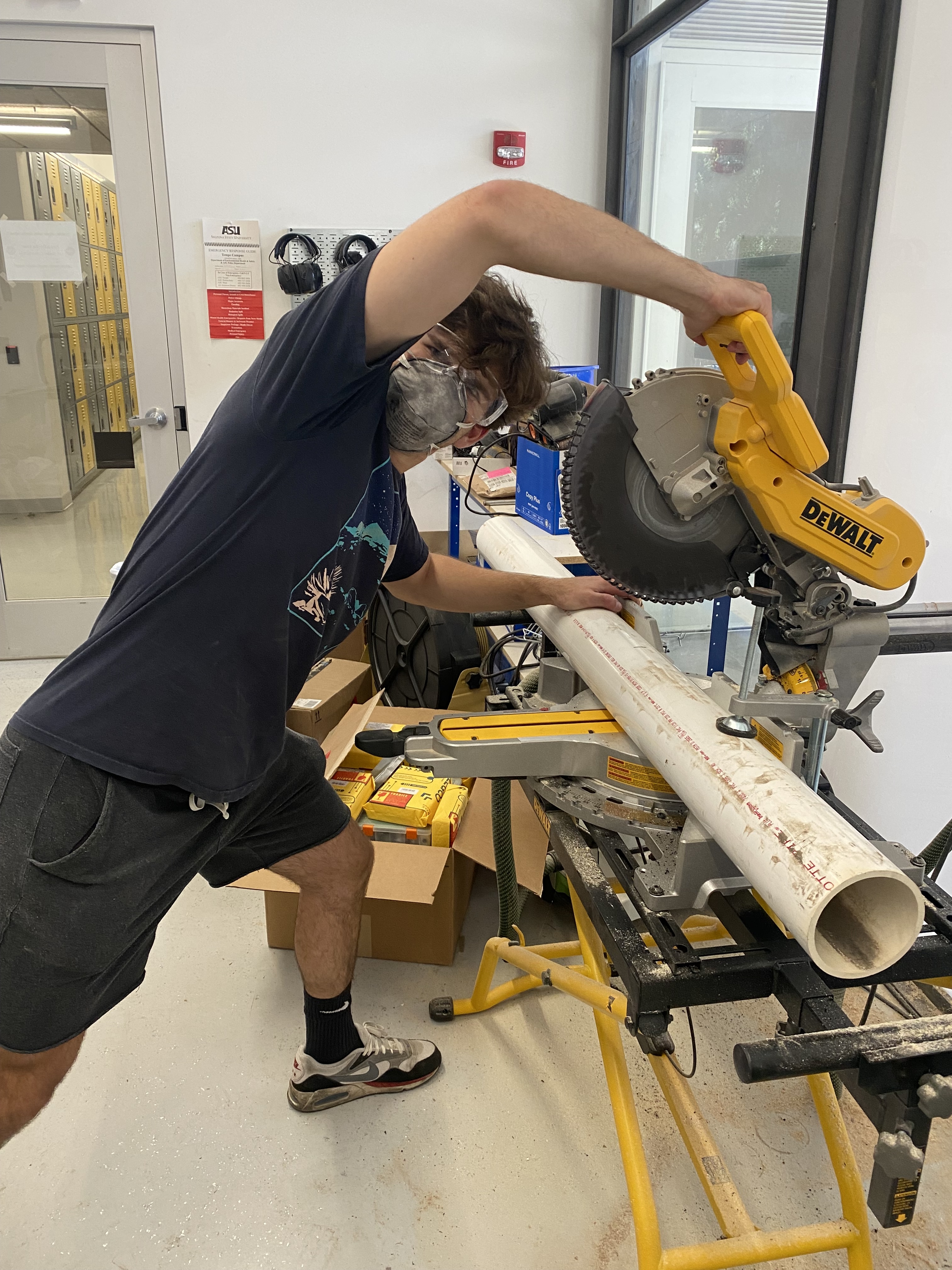 My friend cutting the PVC pipes to size